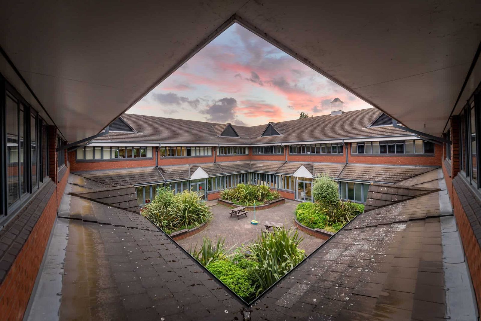 A view of a courtyard from a window in a building.
