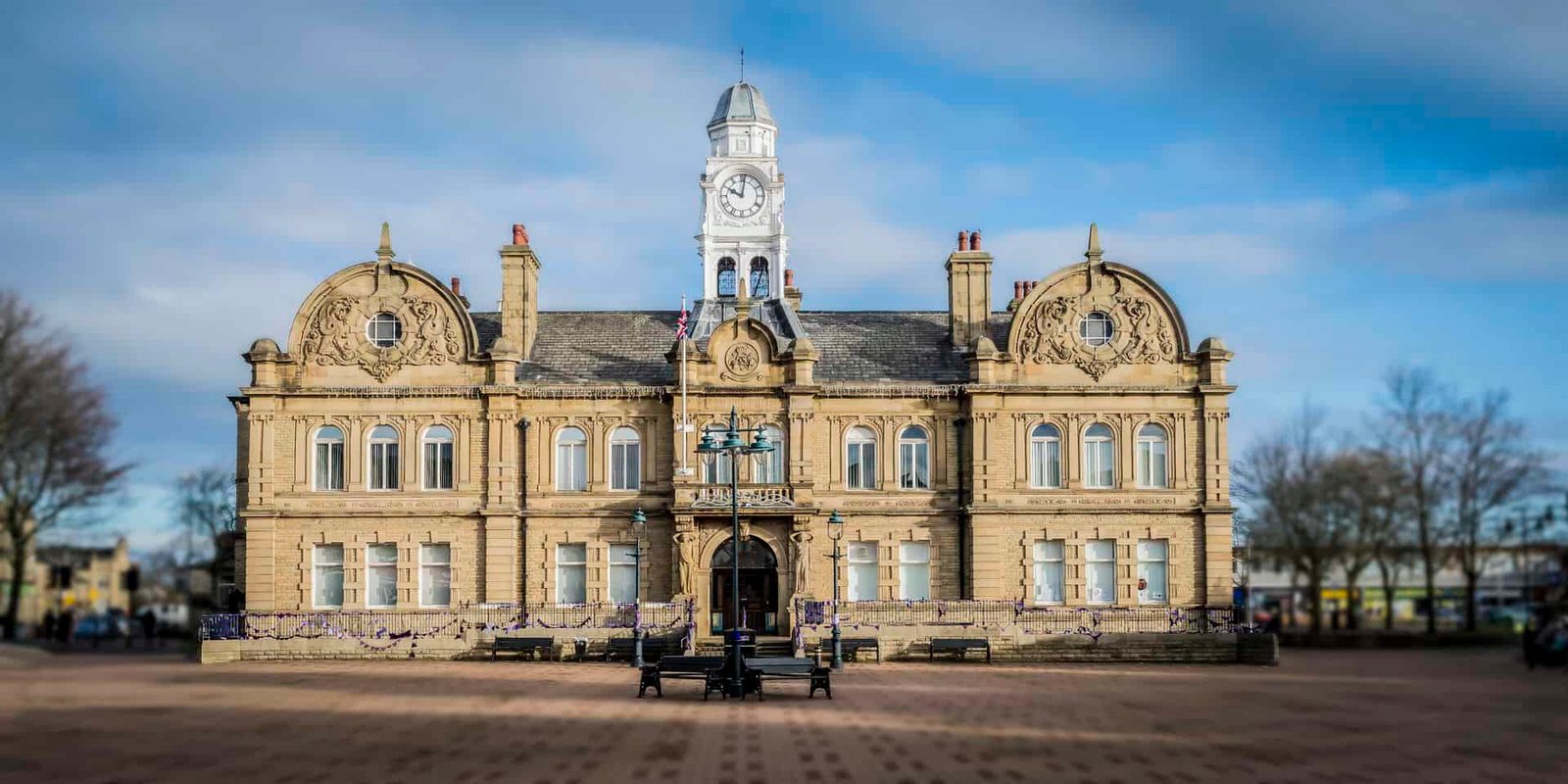 A large building with a clock tower in the middle.