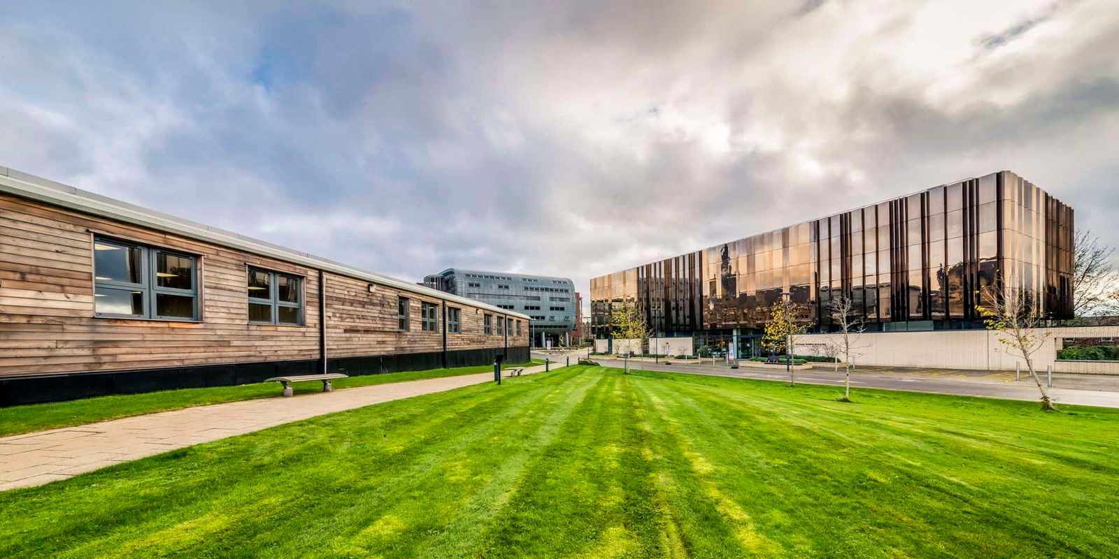 A building with a grassy lawn in front of it.