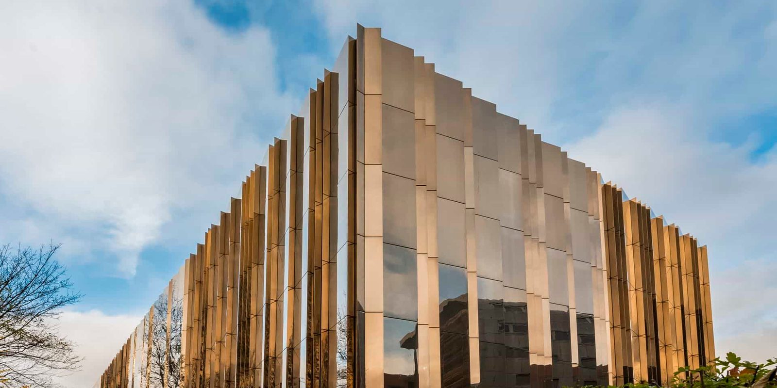 A building with a golden facade on the side of a street.