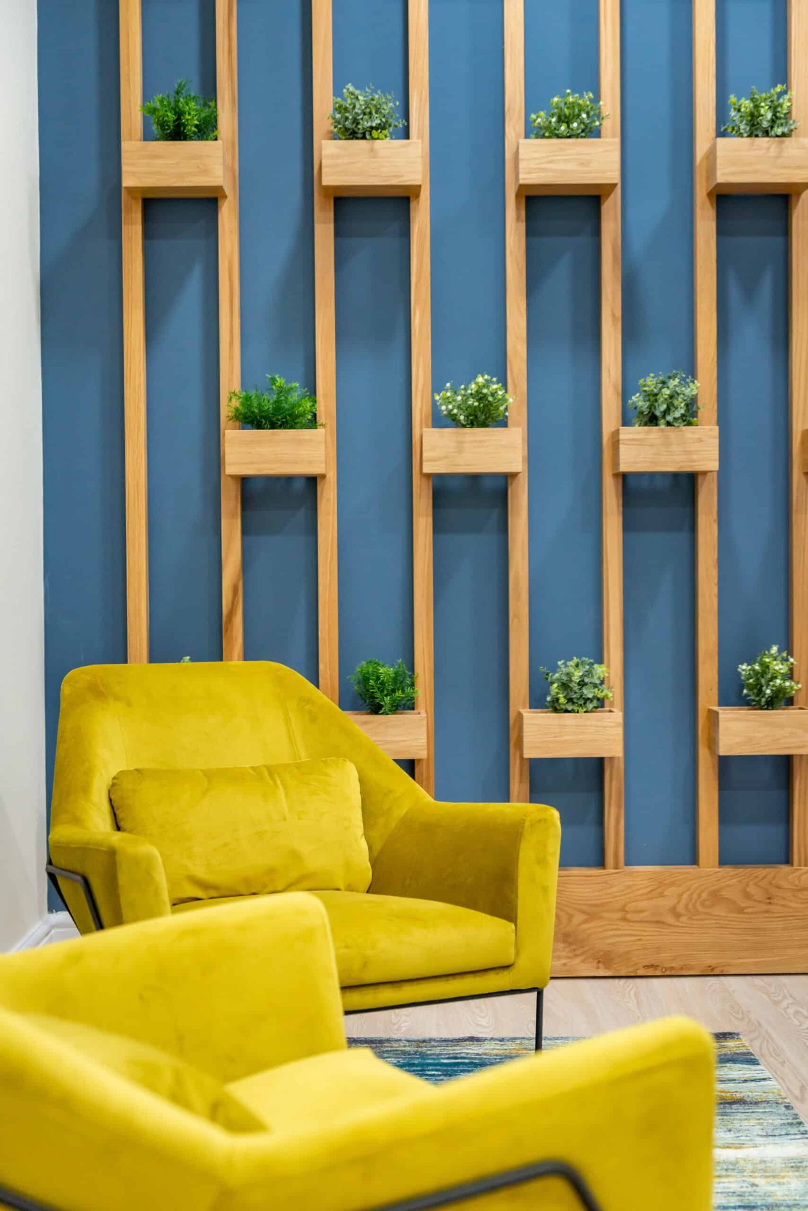 An office with yellow chairs and a blue wall.