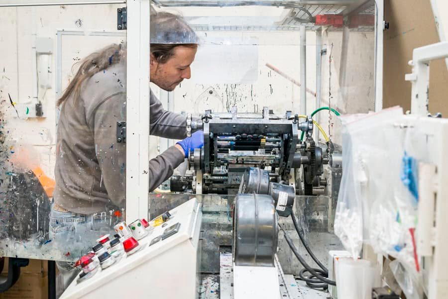 A man working on a machine in a factory.
