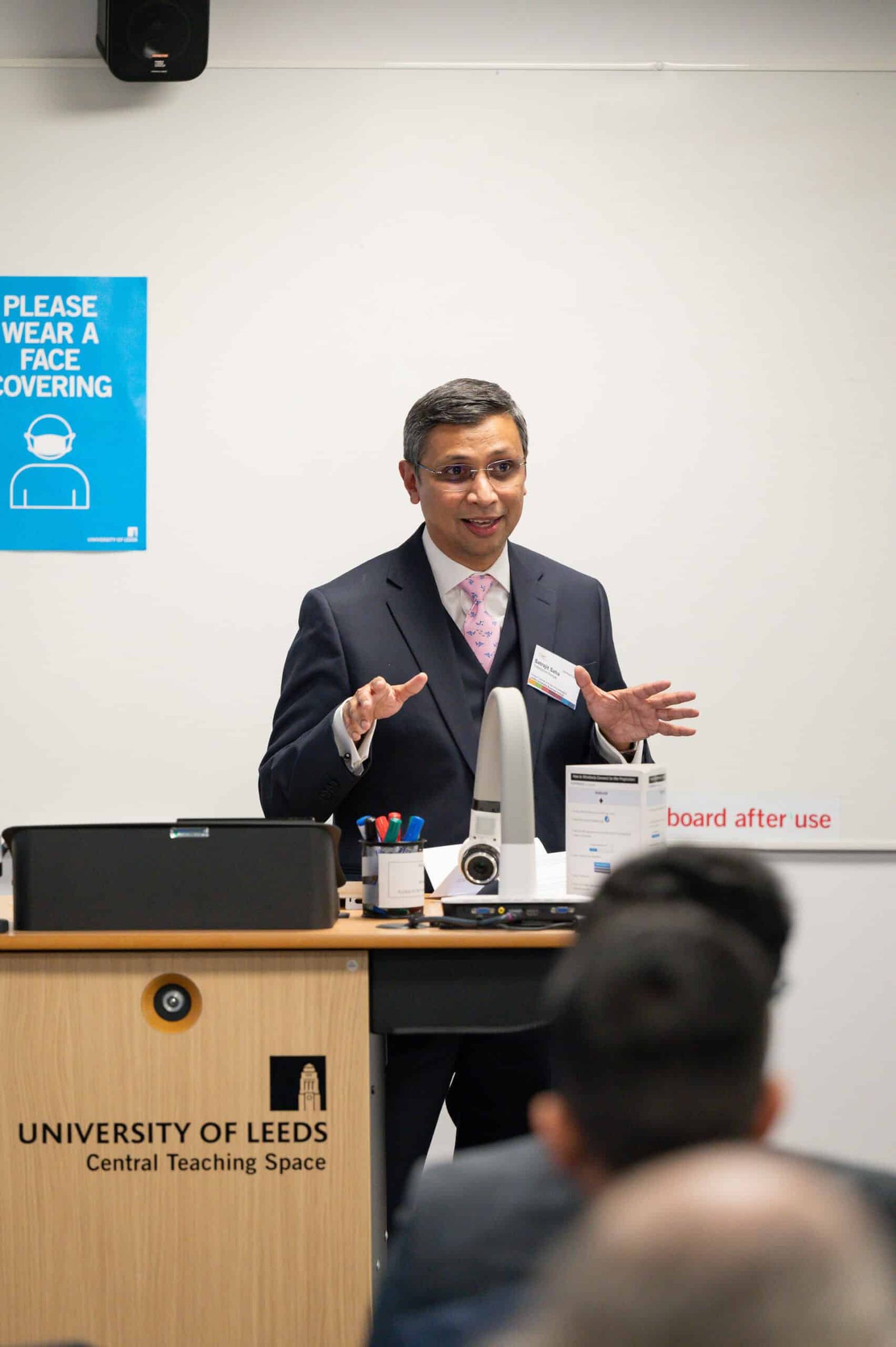 A man in a suit giving a presentation.