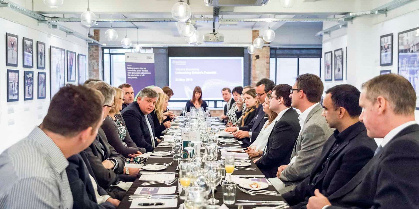 A group of people sitting at a long table.
