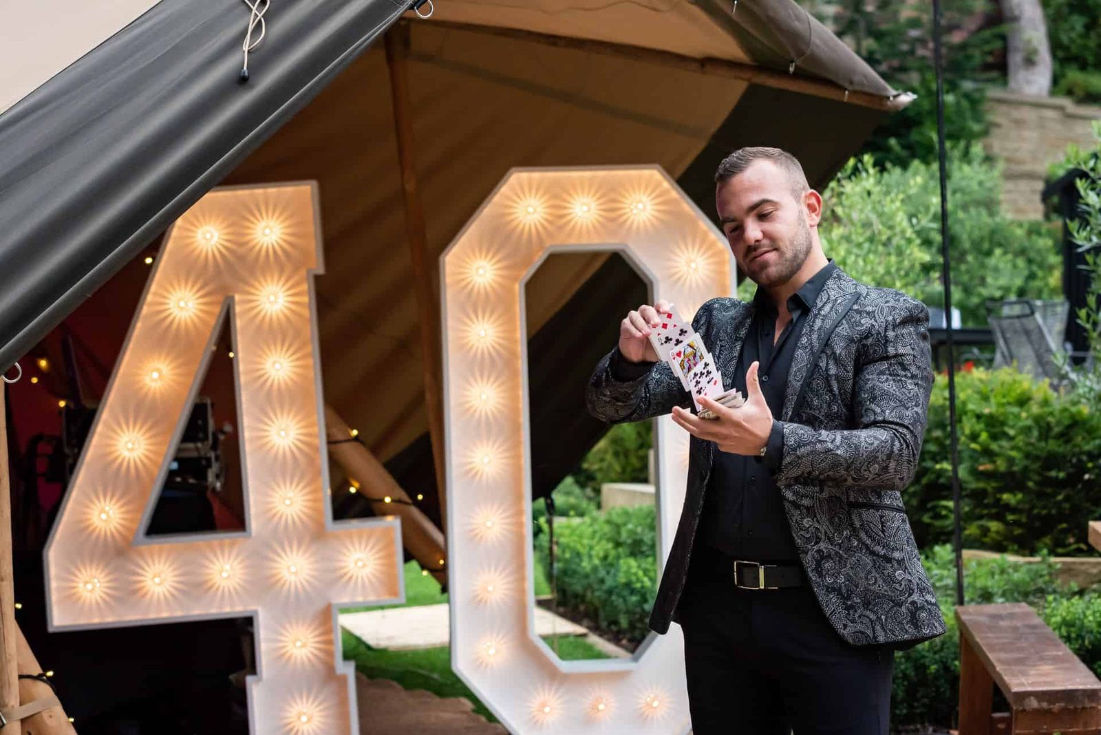A man standing in front of a tent with a number 40 on it.