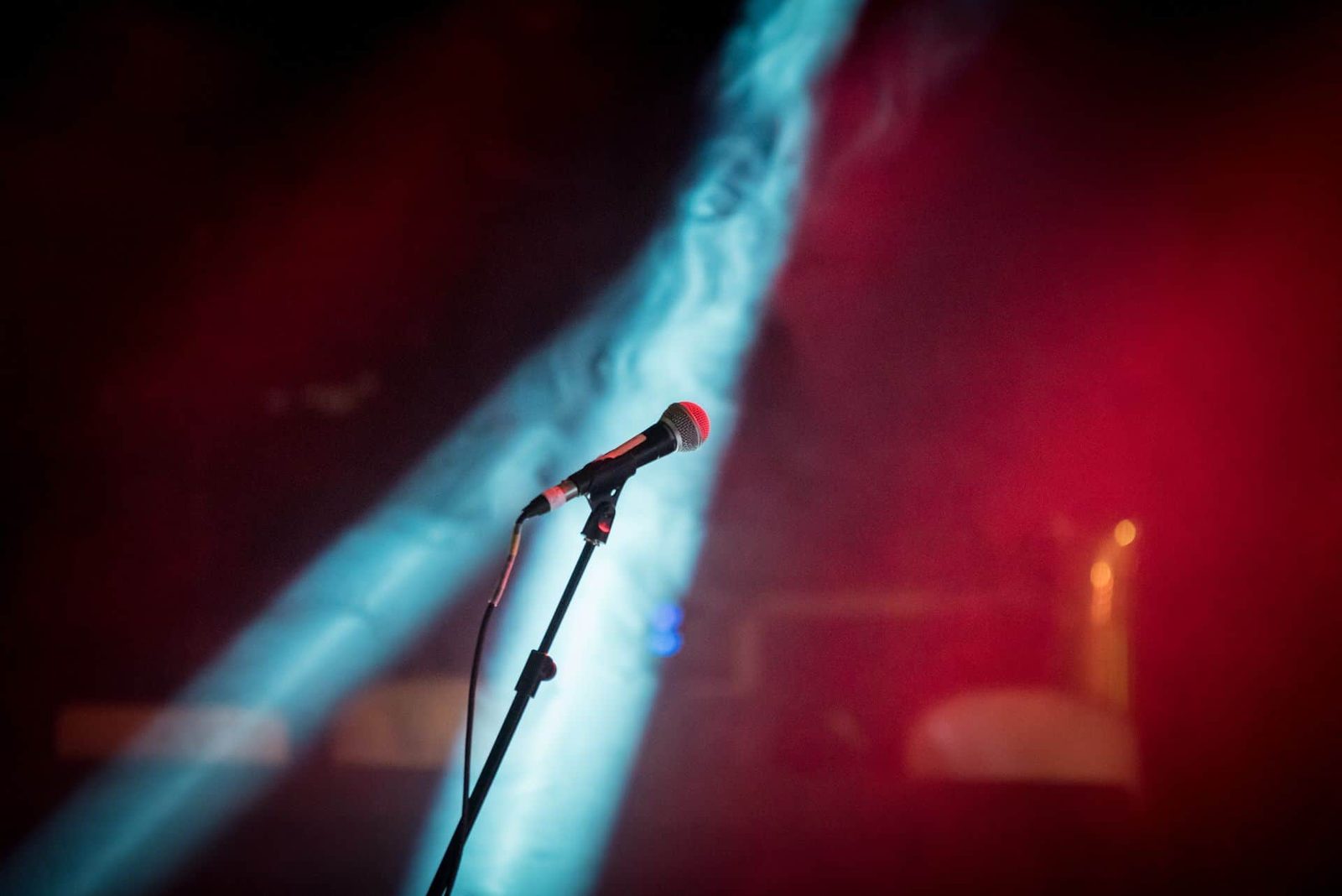 A microphone in front of a red and blue light.