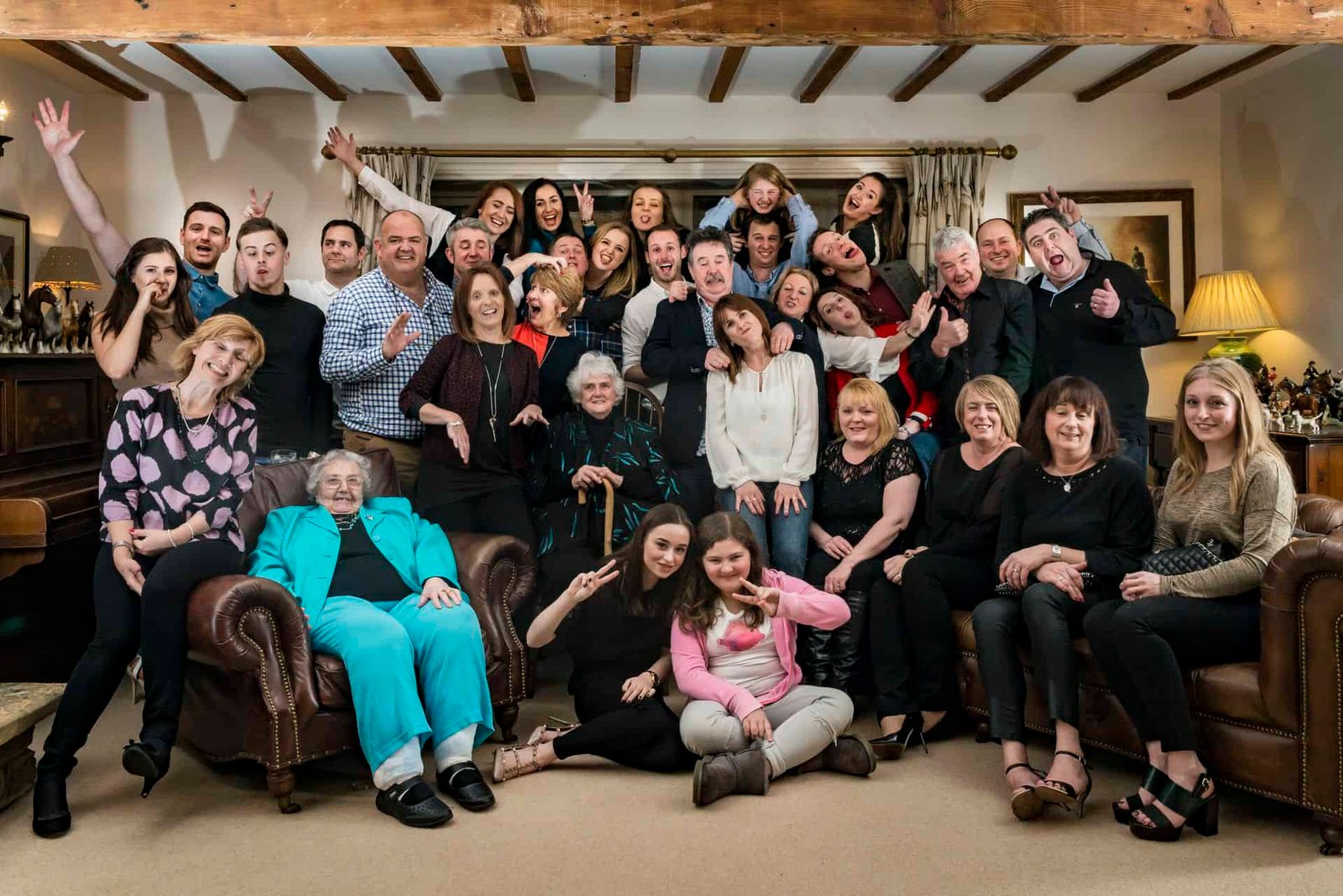 A group of people posing for a photo in a living room.