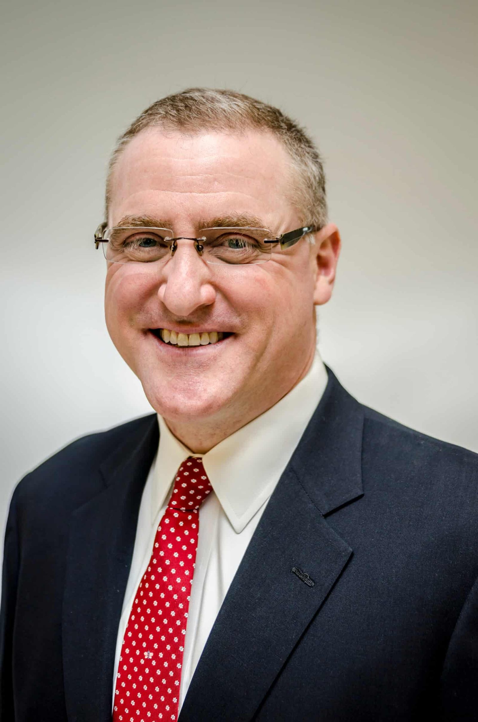A man in a suit and a red tie.