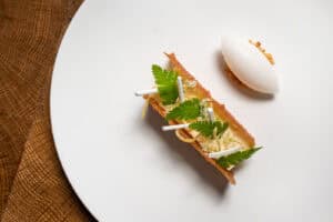 A white plate with a piece of food on it.