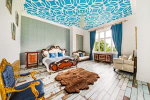 A bedroom with a blue and white patterned ceiling.