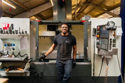 A man standing in front of a cnc machine.