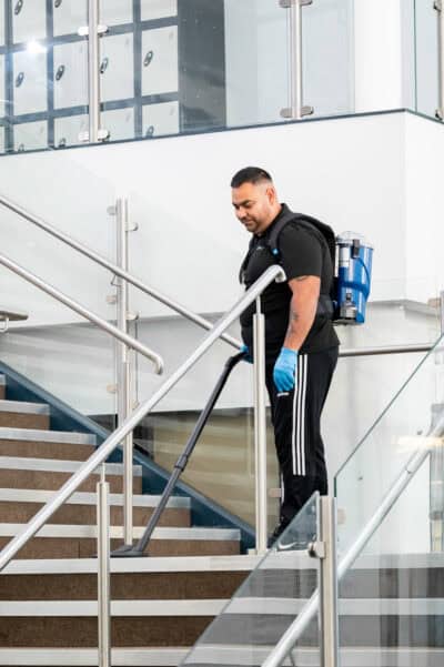 A man cleaning the stairs of a building.