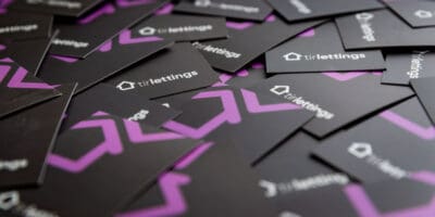 A pile of black and purple business cards.