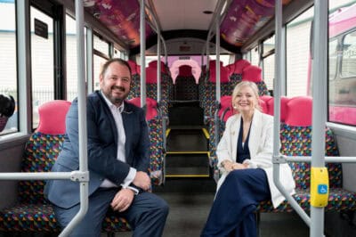 A man and woman sitting on a bus.