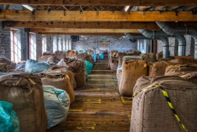 Sacks of coffee beans in a warehouse.