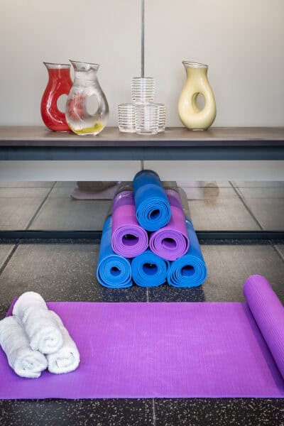 A purple yoga mat on a shelf.