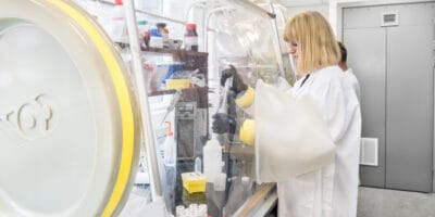 Two women in lab coats working in a lab.