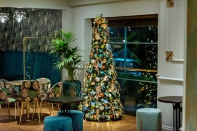 A christmas tree in a hotel lobby.
