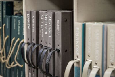 A collection of books on a shelf in a library.