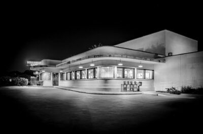 A black and white photo of a diner at night.