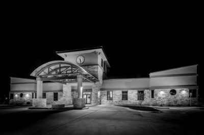 A black and white photo of a building at night.