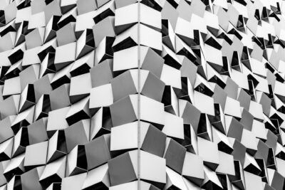 A black and white photo of a building with geometric shapes.