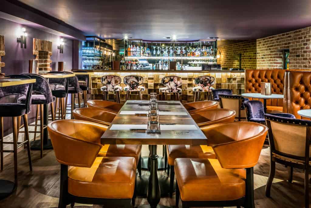 A restaurant with a large table and chairs.