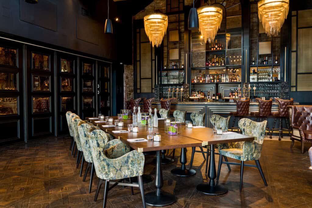 A restaurant with a long wooden table and chairs.