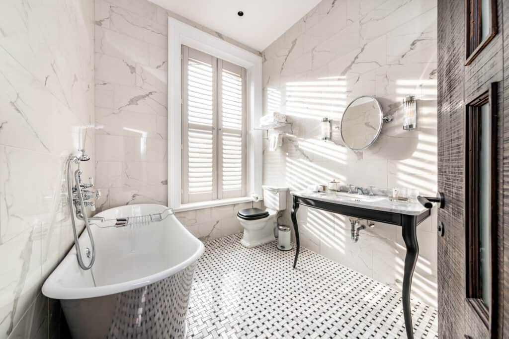 A white bathroom with a bathtub and sink.
