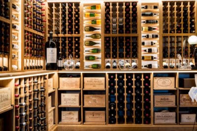 A wine cellar filled with bottles and crates.