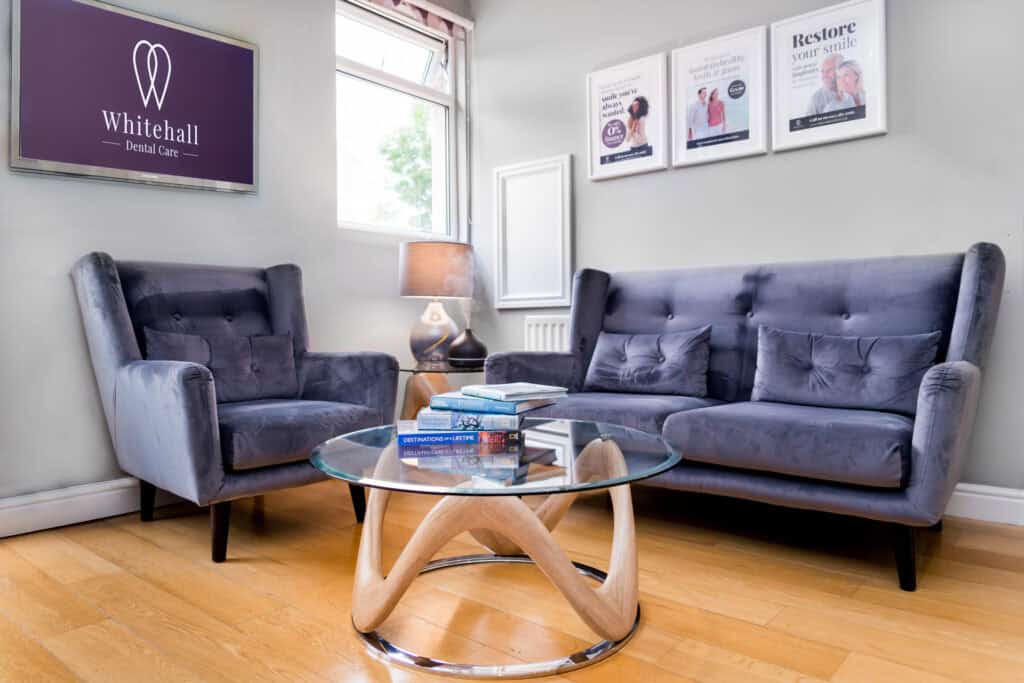 A living room with two grey couches and a coffee table.