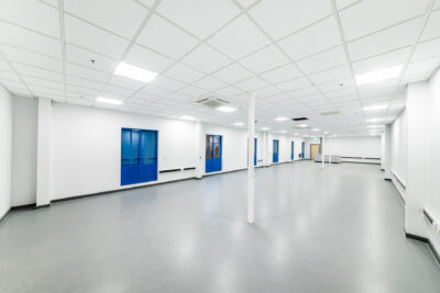 An empty room with blue doors and white walls.