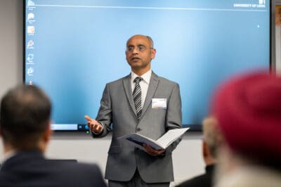 A man in a suit giving a presentation.