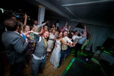 A group of people on a dance floor at a wedding.