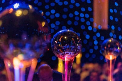 A group of disco balls on a table at a party.