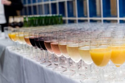 A line of champagne glasses lined up on a table.