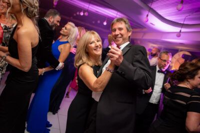 A man and woman dancing at a formal event.