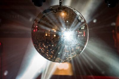 A disco ball hanging from the ceiling at a party.