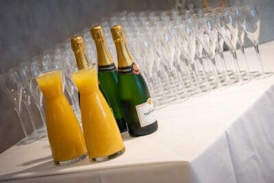 A table with several glasses of champagne and orange juice.