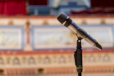 A microphone sits in front of a stage.