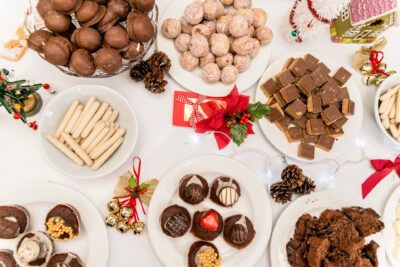 A table with a variety of chocolates, cookies, and candies.