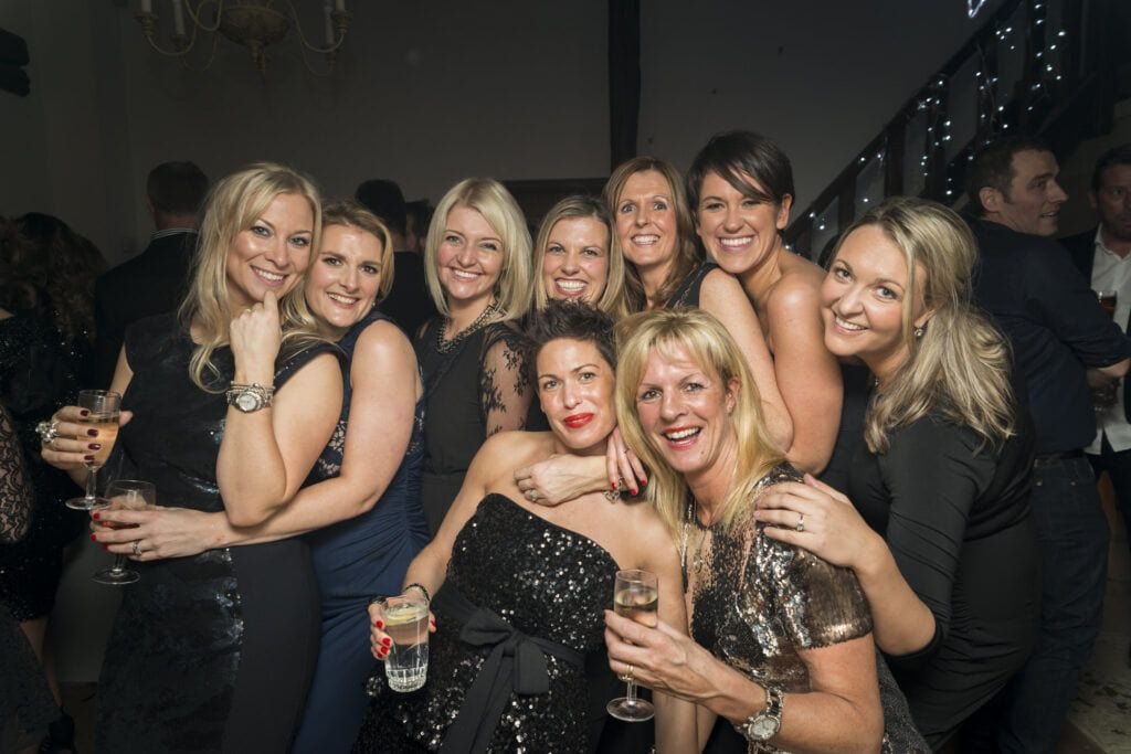 A group of women posing for a photo at a party.
