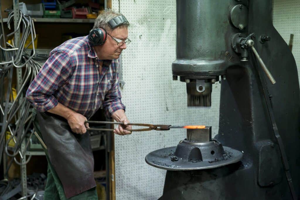 A man working in a blacksmith shop.
