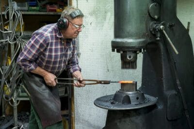 A man working in a blacksmith shop.