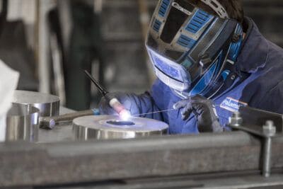 A welder working on a piece of metal.