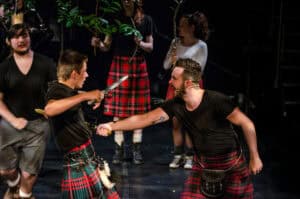 A group of people in kilts on stage.