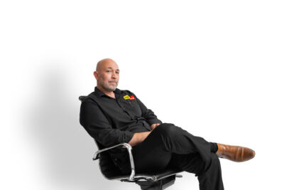 A bald man sitting in an office chair.