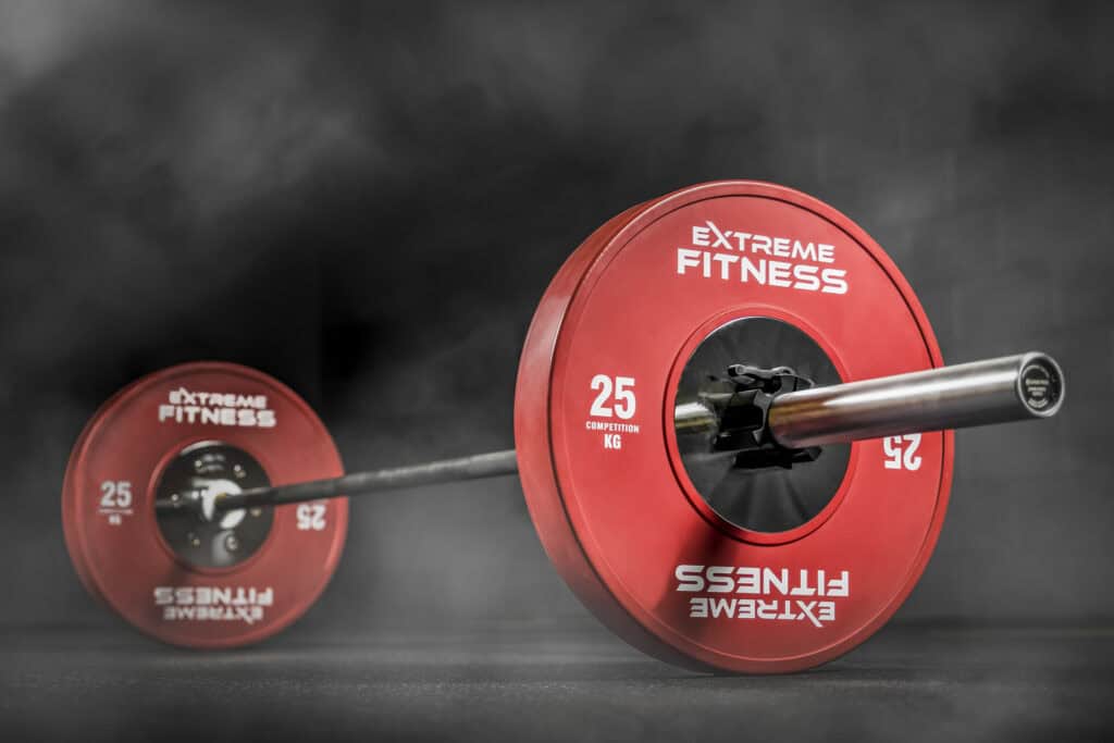 A red barbell on a black background.
