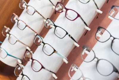 A row of eyeglasses on display in a store.