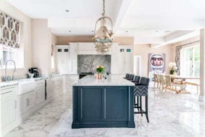 A kitchen with marble counter tops and a marble island.